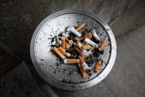 silver ashtray with cigarette butts