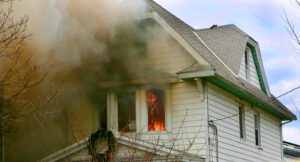 home with holiday wreath on fire